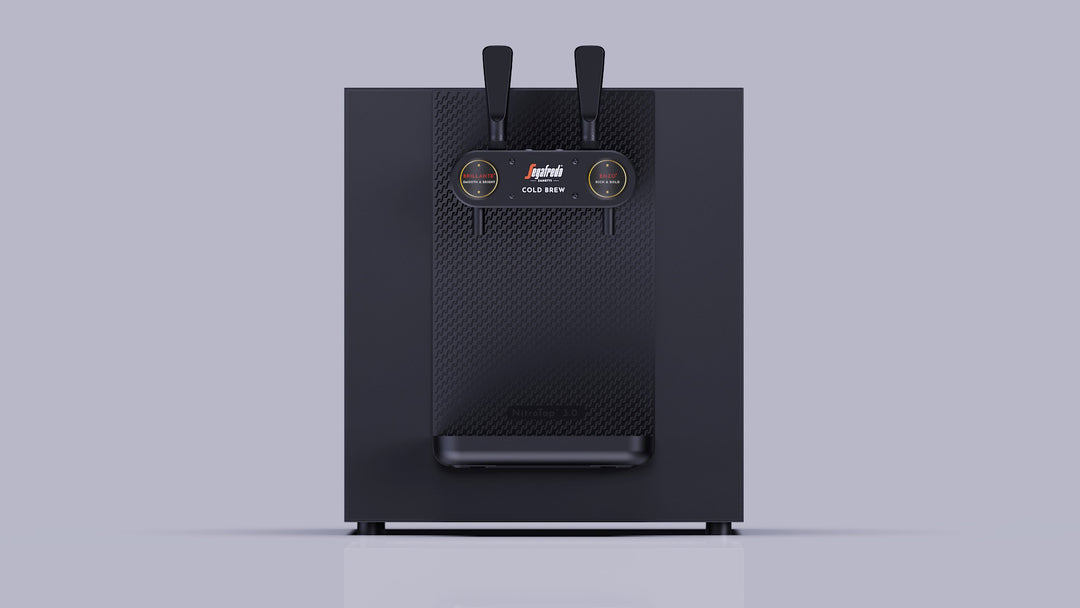 The PRE-ORDER: Nitro Tap by Segafredo Zanetti is a black refrigerated countertop dispenser with dual tap handles and gauges, shown on a plain light gray background. Contact your MZB sales rep for more information.