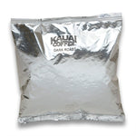 Load image into Gallery viewer, Kauai Coffee Dark Roast in a silver packaged bag, with visibly crumpled and reflective surface.
