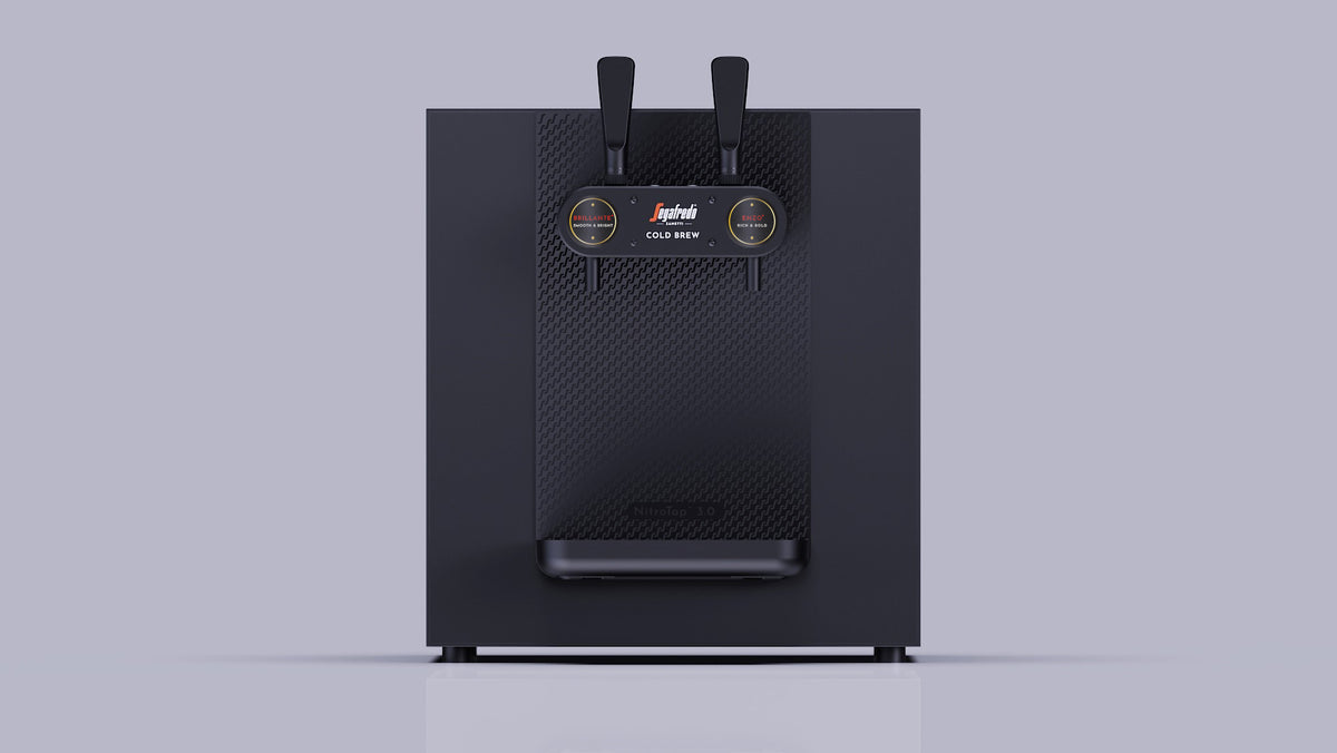 Black countertop Nitro Tap by Segafredo cold brew system with two draft handles and two circular indicator labels on the front panel.