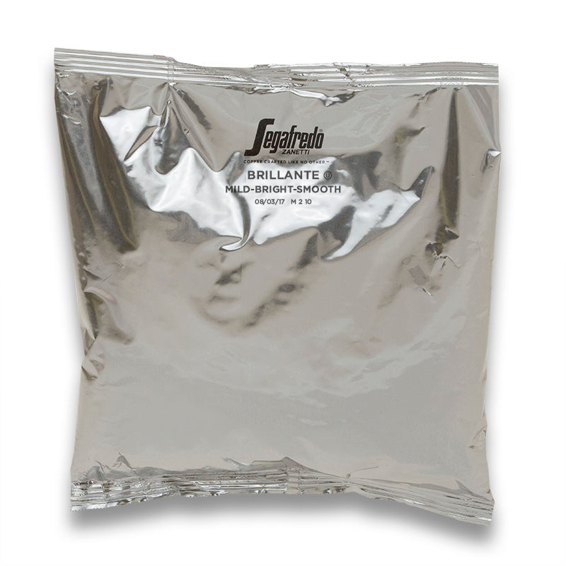 Segafredo Zanetti vacuum-sealed coffee bag with "Colombian Arabica - mild-bright-smooth" printed on it, reflecting light with visible wrinkles and seal lines.
