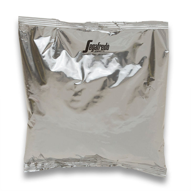 A sealed, silver foil packet with the "Segafredo Zanetti" brand name visible, typical packaging for Segafredo Montagna Dark Roast coffee products.