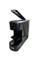 Load image into Gallery viewer, The Segafredo Zanetti® Sky Extra Espresso Capsule Machine is black with an open top lid, cup buttons, and a drip tray.
