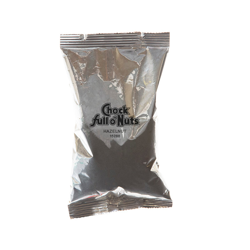A metallic foil packet of Chock full o'Nuts Hazelnut Flavored 100% Arabica Coffee Medium Roast, labeled with product name and number 15288, boasting a rich blend of full-bodied flavor and toasted hazelnuts.