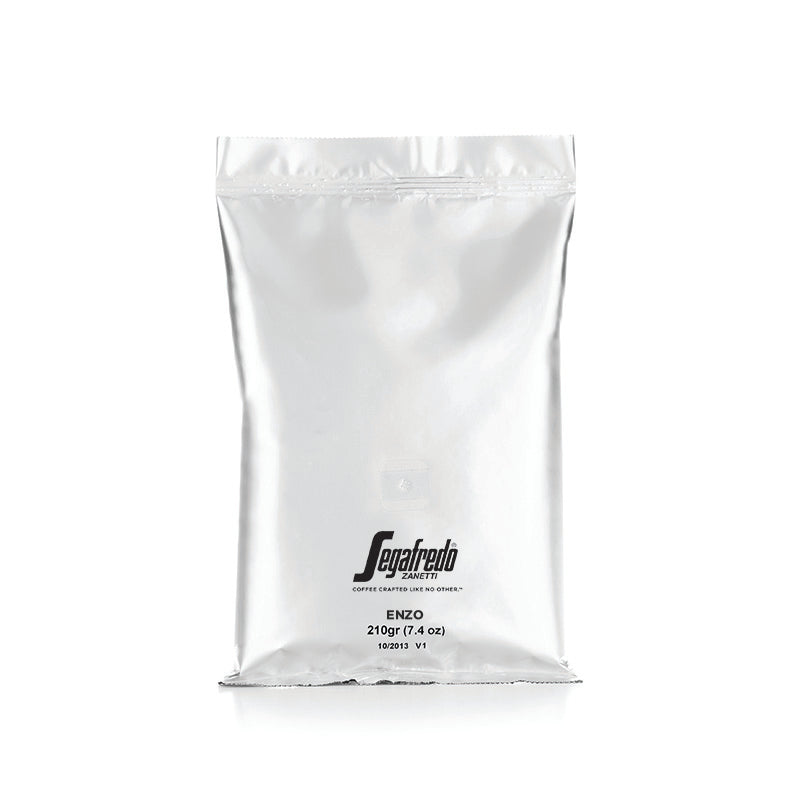 A silver packaging bag of Segafredo Zanetti Enzo Dark Roast coffee, 210 grams, on a plain background.